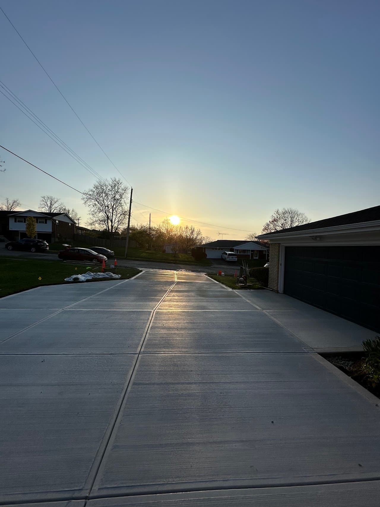 Long concrete driveway running toward a dramatic Ohio sunset