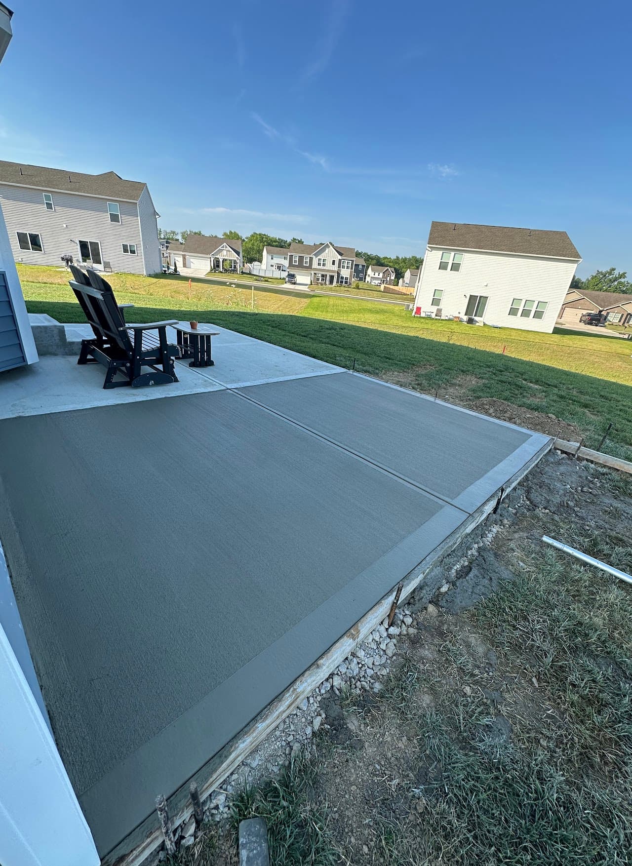 Backyard concrete patio off a modern Ohio home