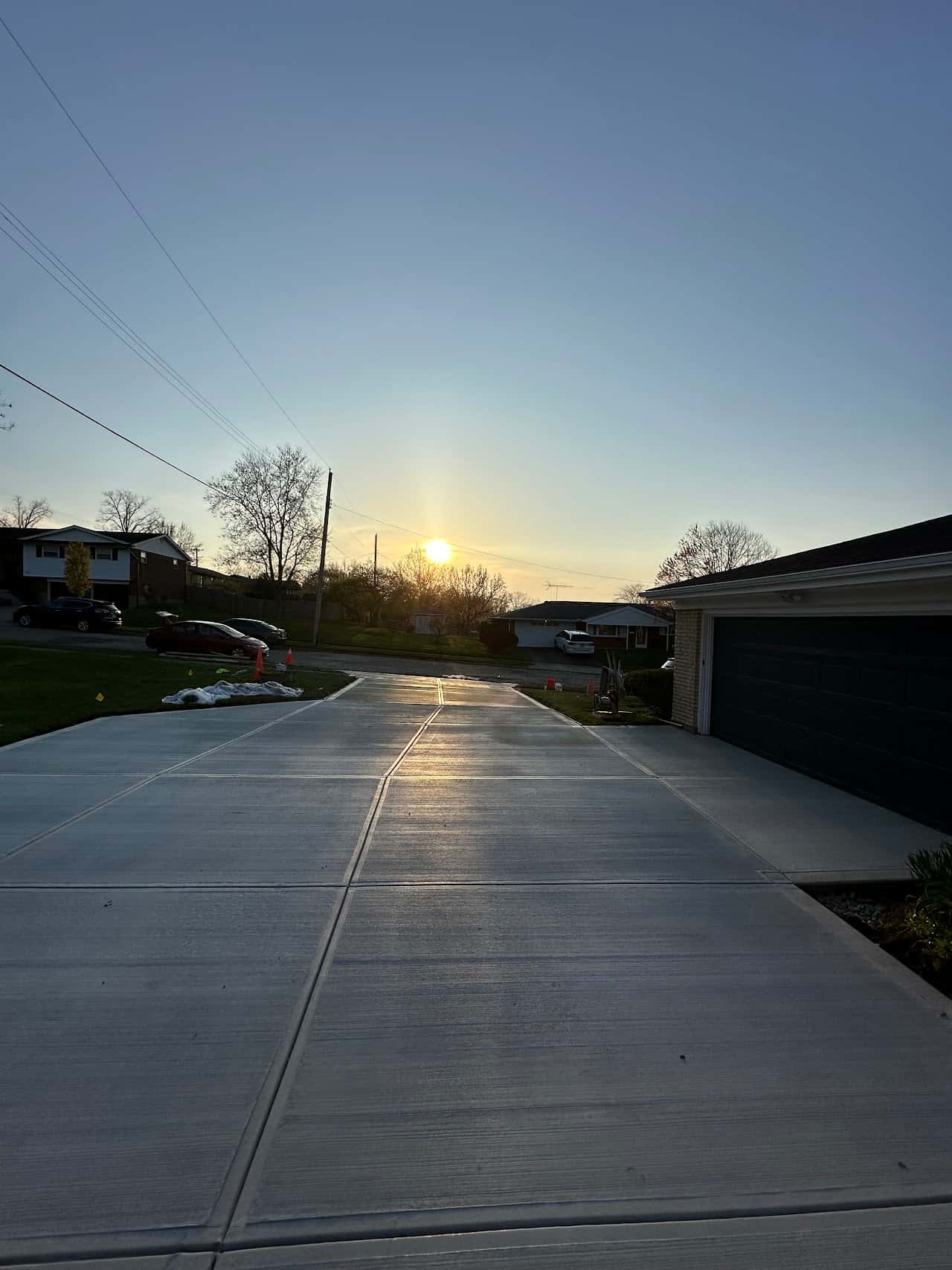 Long concrete driveway running toward a dramatic Ohio sunset