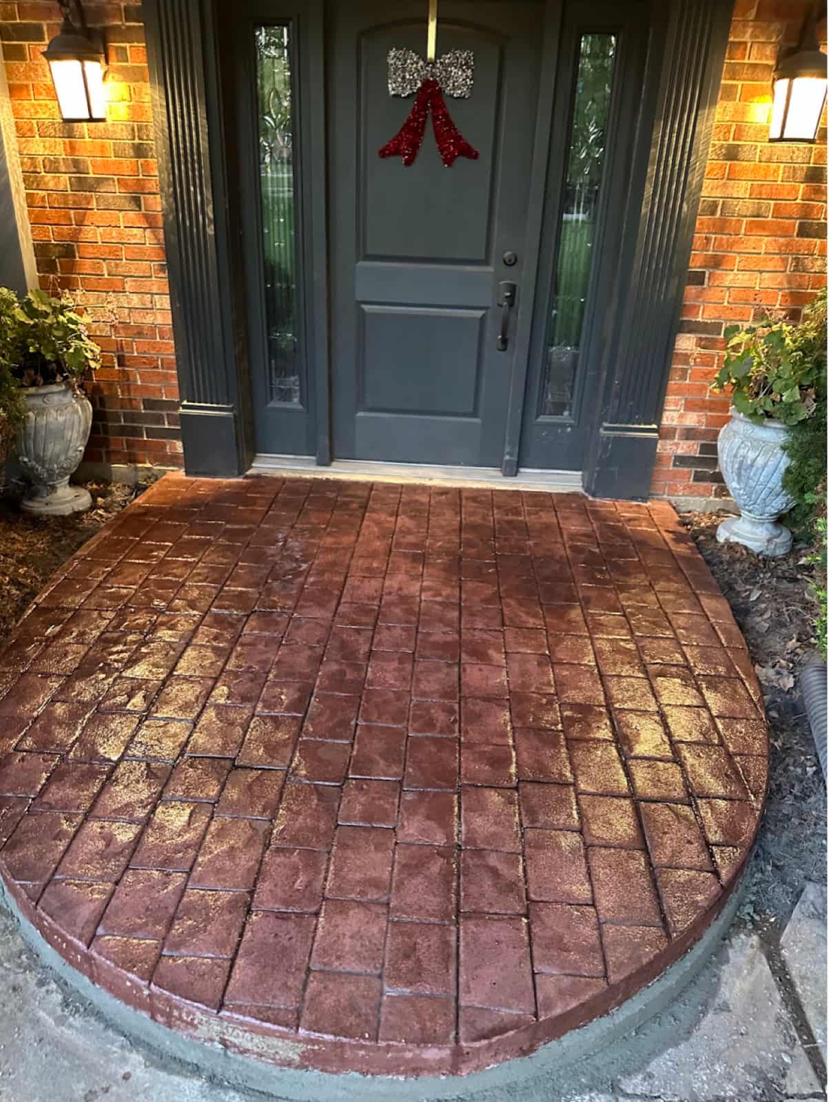 Stamped and colored brick-pattern concrete entry porch in red tones